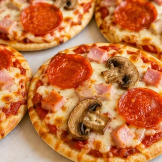 Quick Air Fryer Pita Pizzas - Pita pizza: Make this quick and easy air fryer recipe in under 10 minutes! Crispy pita, melty cheese, and endless topping options