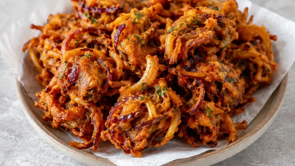Crispy Onion Pakodas: Easy Snack! Onion pakodas: Craft these incredibly crispy Indian fritters using your air fryer. A healthier take on a classic, perfect for