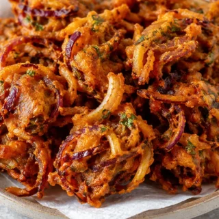 Crispy Onion Pakodas: Easy Snack! Onion pakodas: Craft these incredibly crispy Indian fritters using your air fryer. A healthier take on a classic, perfect for